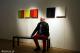 Przemysław Karwowski na tle swoich obrazów w Mark Rothko Art Centre w Daugavpils