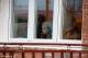 Chłopiec obserwuje przez okno, jak pracownicy MPGKiM zabierają choinkę sprzed domu