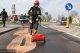 strażacy rozsypują specjalny proszek wchłaniający olej